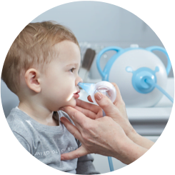 An ENT doctor clearing a boy's nose with the help of a safe baby nasal aspirator Nosiboo Pro